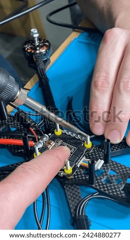 twisting, soldering, assembly, fpv drones part assembled by human. Close-up, high technology, drones