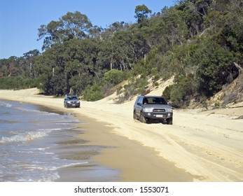 Two 4wd Driving Along The Beach Highway.