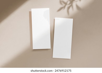 Two 4x9 blank menu cards mockup on minimalist neutral background with leaf shadows and spot light