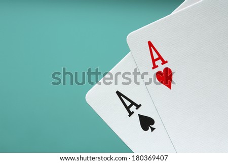 Two Ace playing cards on blue background