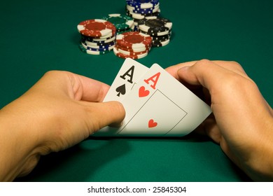 Two aces in hand in game poker on the green casino table
