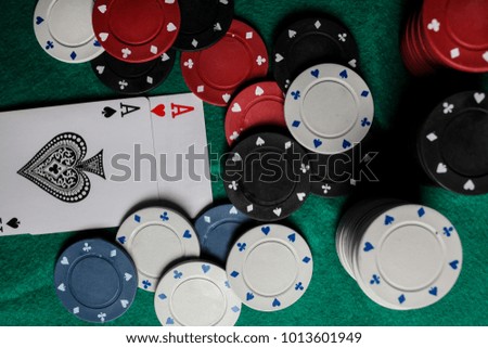 two aces in the hands of a close-up. An concept Image of a poker table. two aces, two playing cards and poker chips on the green casino table / on a black background. success in gambling. soft focus