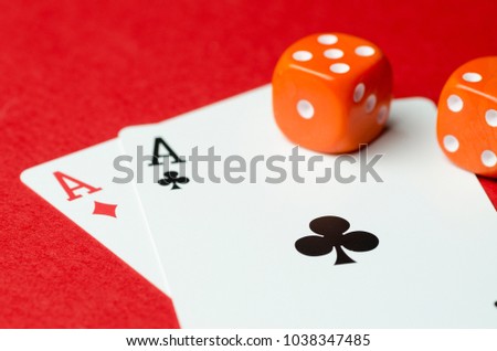 Two aces and red cubes. Red background, close up