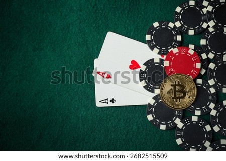 Two aces sit face up on a green felt poker table surrounded by black and red poker chips, along with a Bitcoin coin, capturing the thrill of a weekend game night.