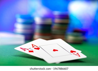 Two aces and stack of Casino Chips in background.