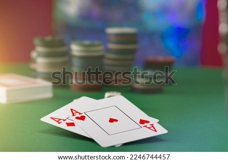 Two aces and stack of Casino Chips in background
