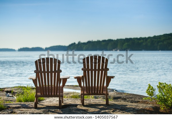 Two Adirondack Chairs Sit On Rock Stock Photo Edit Now