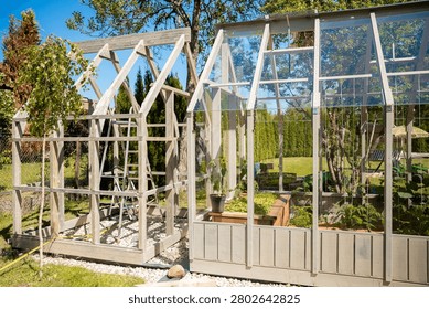 Two adjoining structures sit in a private garden at midday. Left frame shows timber under construction with ladder. Right shows tempered glass, vent windows, and planter beds.