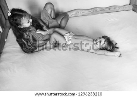 Similar – Young woman caressing man face lying over bed