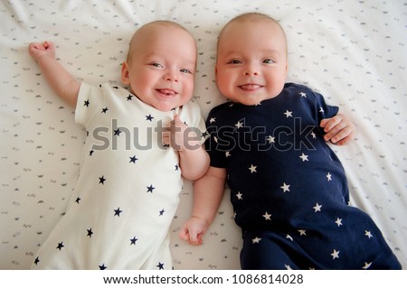 Two adorable twin babies smiling happily. Positive lifestyle concept. Happy childhood