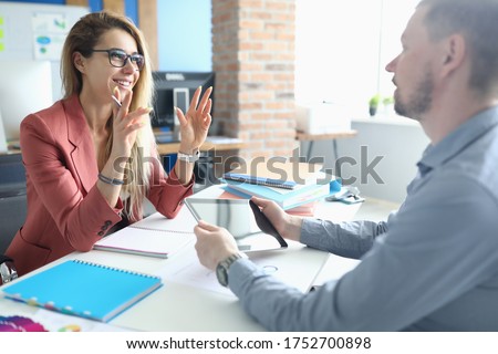 Two adult business people make work interview against office background.One on one meeting concept.