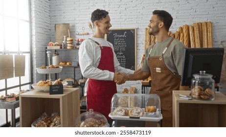 Two adult men bakers in an indoor bakery shop shaking hands, surrounded by various pastries and bread, showcasing a professional collaboration and friendly gesture. - Powered by Shutterstock