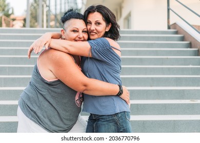 Two Adult Twin Sisters Hugging. Different Styles