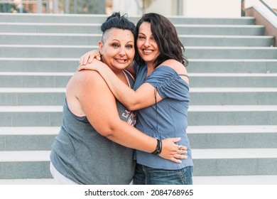 Two Adult Twin Sisters Hugging. Different Styles