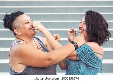 Two Adult Twin Sisters Playing With Each Other