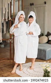 Two Adult Women Plus Size Models. Mom And Daughter Relax. A Great Family Day At The Spa. In Bathrobes And Towels