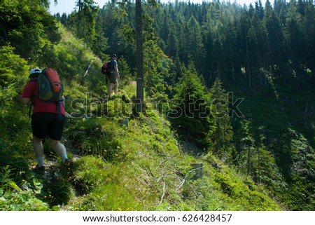 The two adults climbing the mountains in Austria, Alpbach, Schatzberg