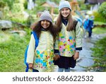 Two affectionate junior school learners in campus