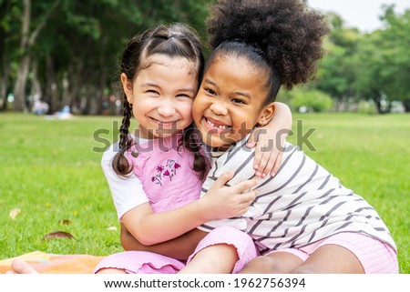 Similar – Two kids sitting on a bench and admiring the scenery