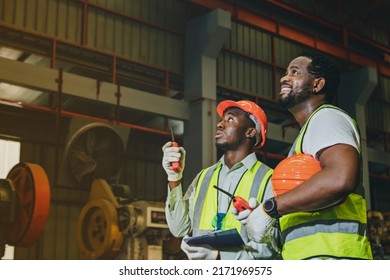 Two african american engineer workers in hats stand production meeting to explain brainstorming together at sheet metal factory to ensure smooth and safe work : Selected focus - Powered by Shutterstock