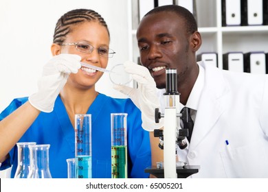 Two African American Lab Technicians Doing Experiment In Lab