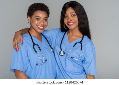 Two African American Nurses Working Their Shift In The Hospital