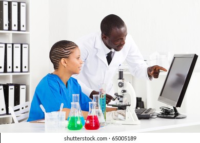 Two African American Scientists Working In Lab Together