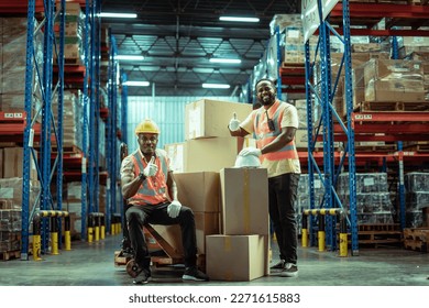 Two African American warehouse workers showing teamwork and partnership. teamwork at warehouse storage department. - Powered by Shutterstock