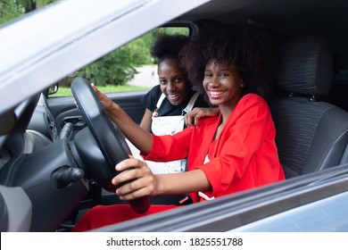 the two African American women having fun in the car - Powered by Shutterstock