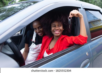 the two African American women having fun in the car