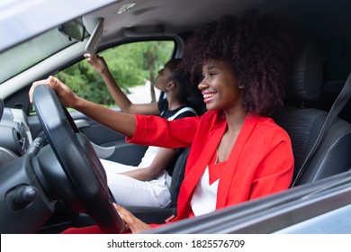 the two African American women having fun in the car - Powered by Shutterstock