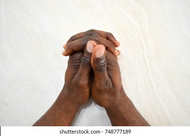 Two African Dark Skin Hands Clasped Together Isolated On White Background 