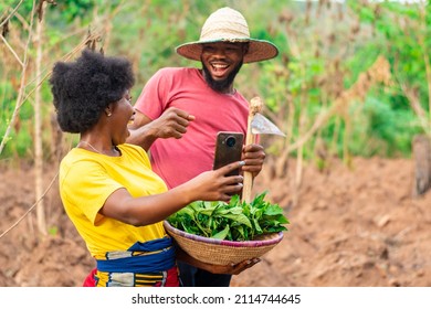 Two African Farmers Excited After Checking A Phone