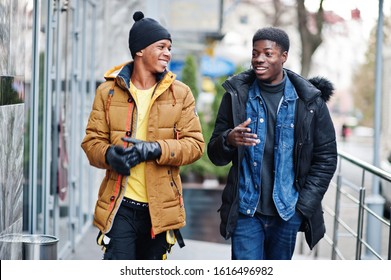 Two African Male Friends Talking Together, Wear On Jackets At Cold Weather.