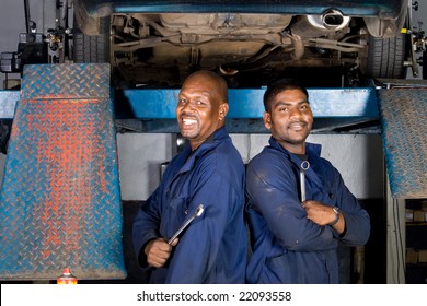 Two African Mechanic In Side Garage