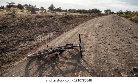 Two African Men Repair A Flat Bike Tyre In Tanzania