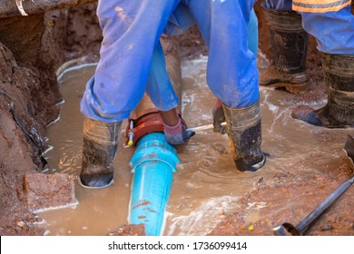 Two African Repairman Attending To The City Water Supply Repairs In Gaborone Botswana