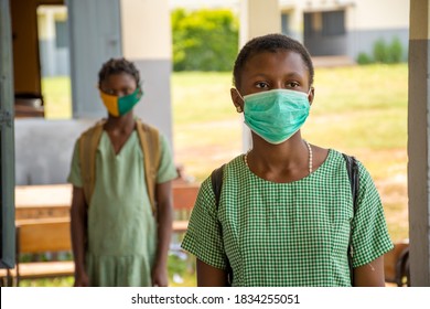 Two African School Kids Wearing Face Masks And Observing Physical Distancing