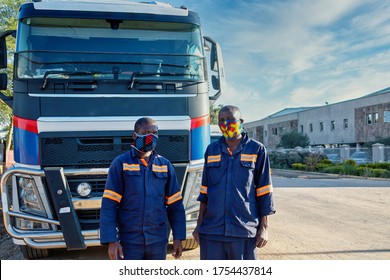 Two African Trucker Wearing A Mask, Outdoors View In The Front Of A Truck, In The Street