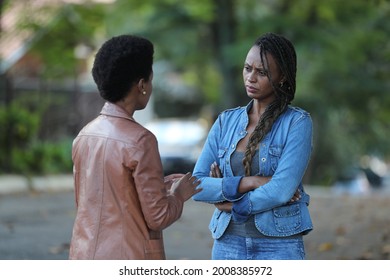 Two African Women Speaking In Conversation Outside In Street