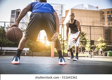 Two afroamerican athletes playing basketball outdoors - Basketball athlete training on court in New York
