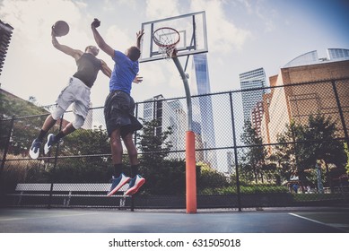 Two afroamerican athletes playing basketball outdoors - Basketball athlete training on court in New York