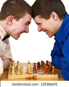 Two aggressive chess opponents fights with his forehead under chess board