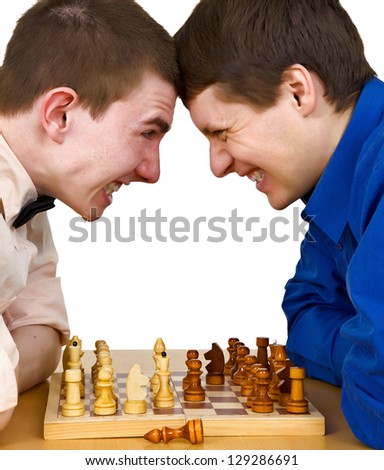 Two aggressive chess opponents fights with his forehead under chess board