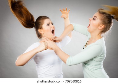 Two Agressive Women Having Argue Fight Being Mad At Each Other. Female Violance Concept.