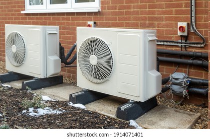 Two air source heat pump units installed on a modern house - Shutterstock ID 1914071401