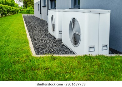 Two air source heat pumps installed outside of new and modern city house, green renewable energy concept of heat pump - Shutterstock ID 2301639953