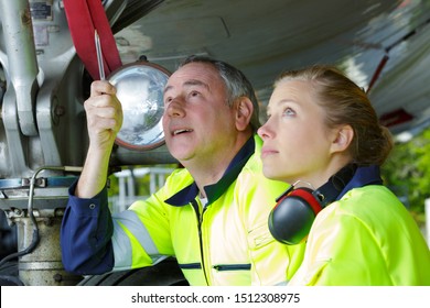 two aircraft engineers inspecting plane construction - Powered by Shutterstock