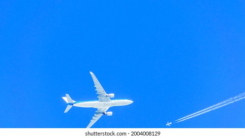 Two Airplanes In The Sky Crossing Paths At Different Flight Travel Altitudes.