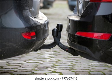 Two Almost Identical Towbars From Two Almost Identical Cars In The Parking Lot.